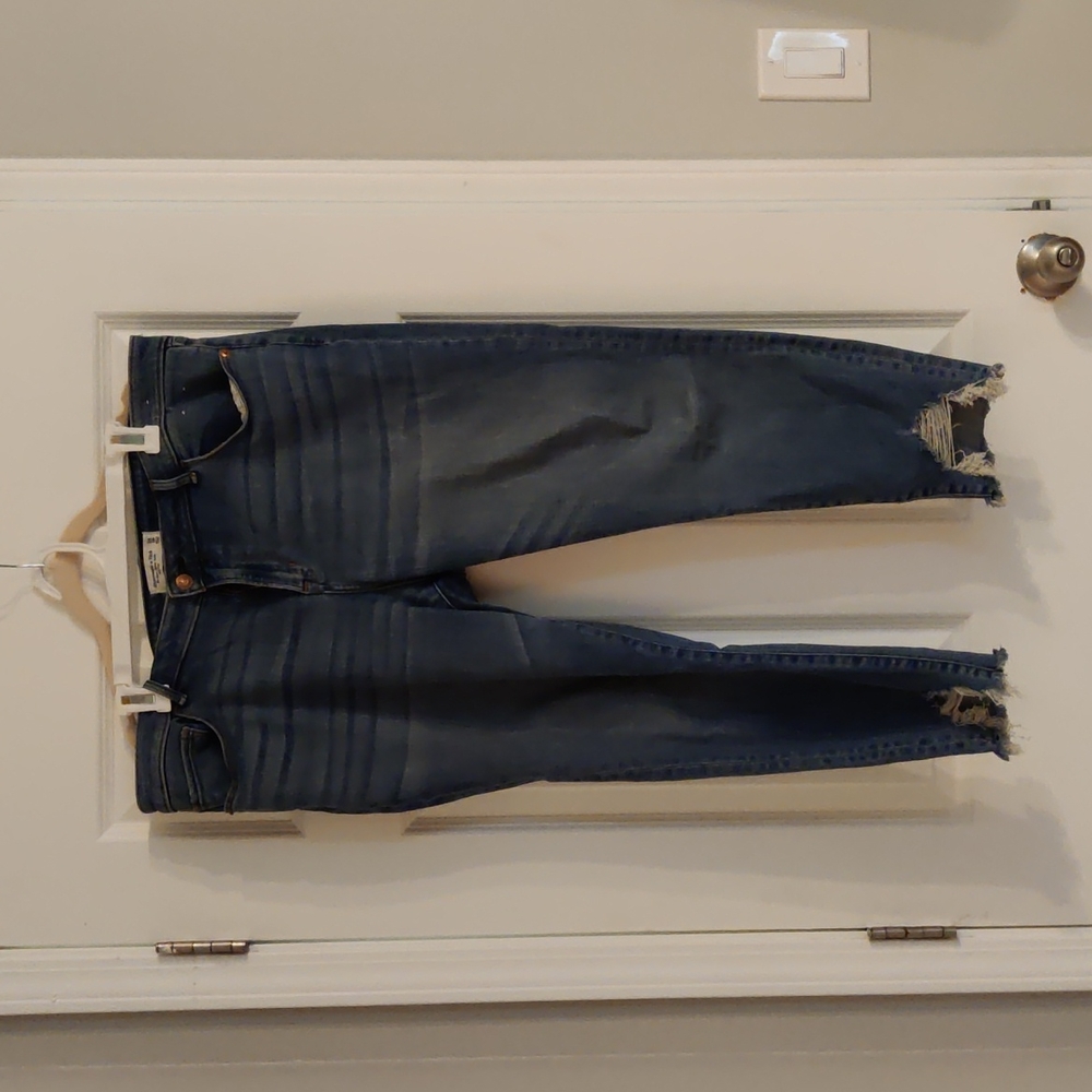 Abercrombie and Fitch Super Skinny Ankle mid-rise jeans with distressed hem.